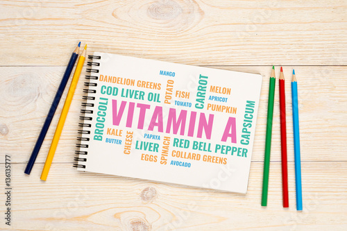vitamin a foods cloud, notebook with colorful pencils over white