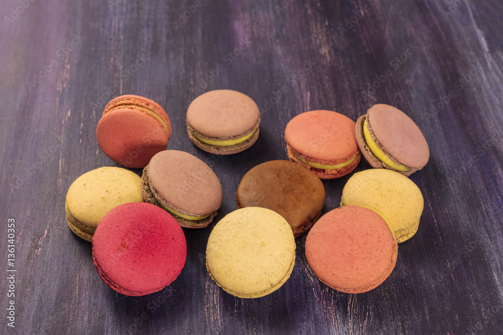 Various macarons on vibrant purple texture Various macarons on vibrant purple texture