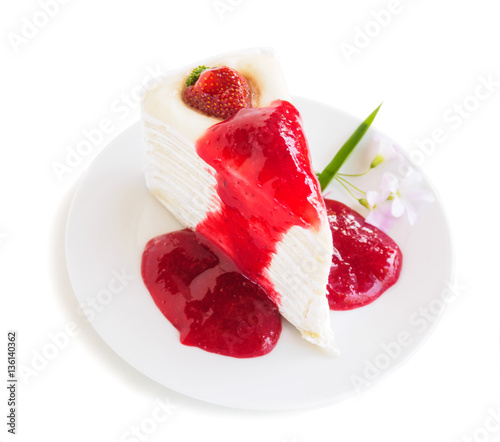 Strawberry crape cake with jam on plate