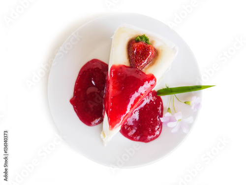 Flat lay dessert cake with strawberry jam on dish of isolated