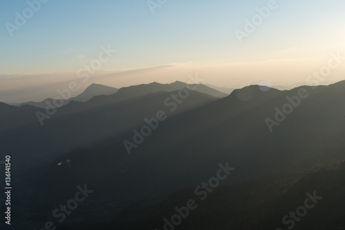 Silhouette of Mountain Layers with sunlight © Natapol