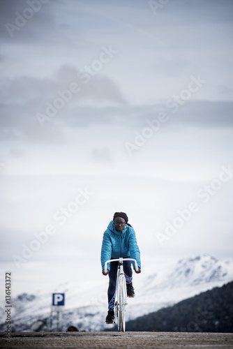 Woman cycling on white bike photo