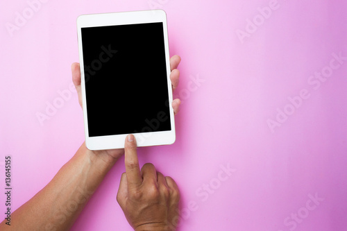 hand using tablet on top view. Clipping path included.