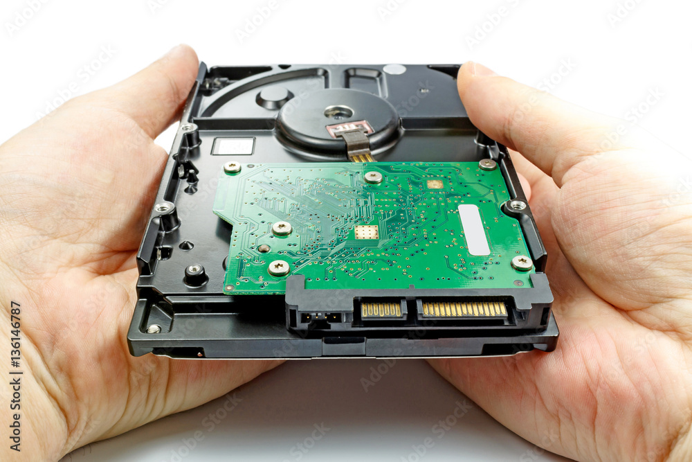 Hard disk drive in the engineer's hands on a white background Hard disk drive in the engineer's hands on a white background