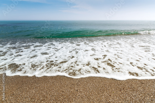 calm waves at the beach   hot summer day photo Crimea