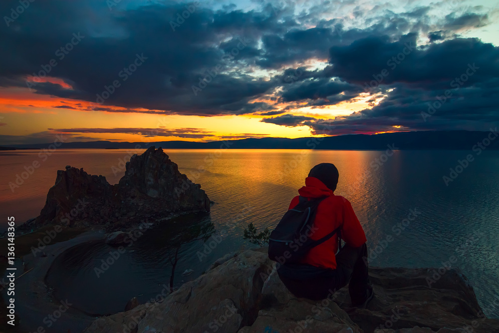 Man admiring the sunset at Cape Burhan on Olkhon