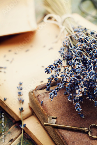 Fototapeta Naklejka Na Ścianę i Meble -  Retro still life with vintage books, old key and lavender flowers, nostalgic composition.