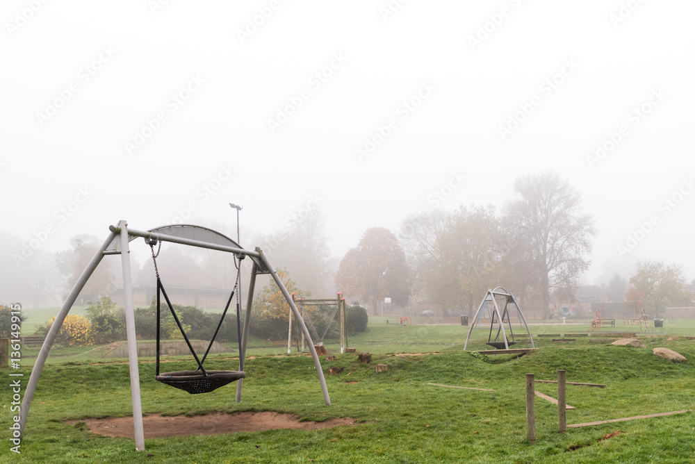 Early morning view of empty playground with fog around it Early morning view of empty playground with fog around it