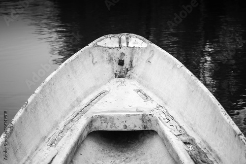 Canvas Print Empty bow of old white grungy rowboat