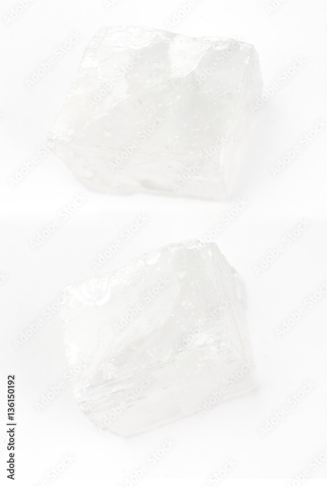 The transparent Iceland spar crystals on a white background.