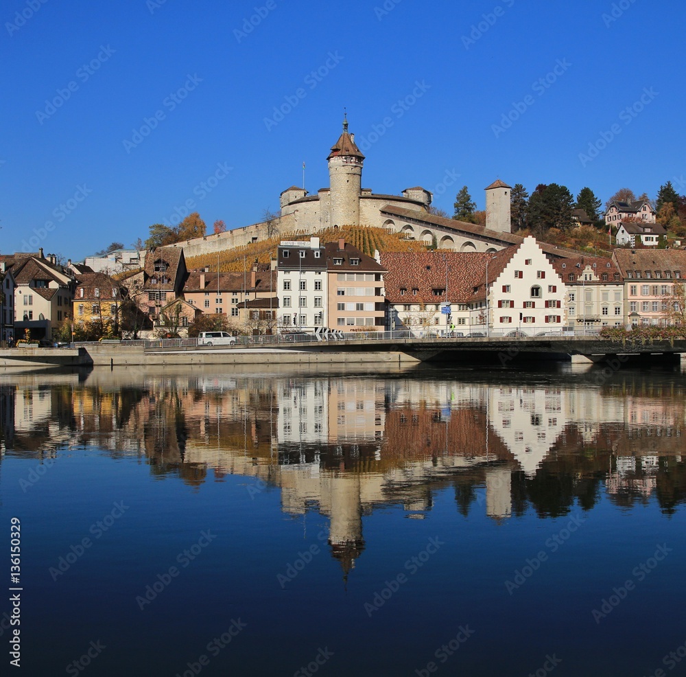 Medieval castle Munot and other old buildings mirroring in the river Rhine
