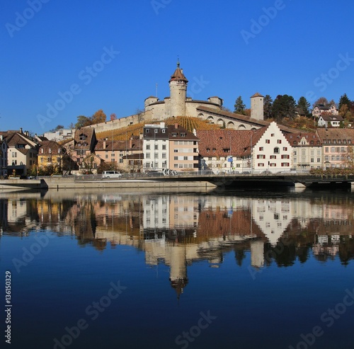 Medieval castle Munot and other old buildings mirroring in the river Rhine