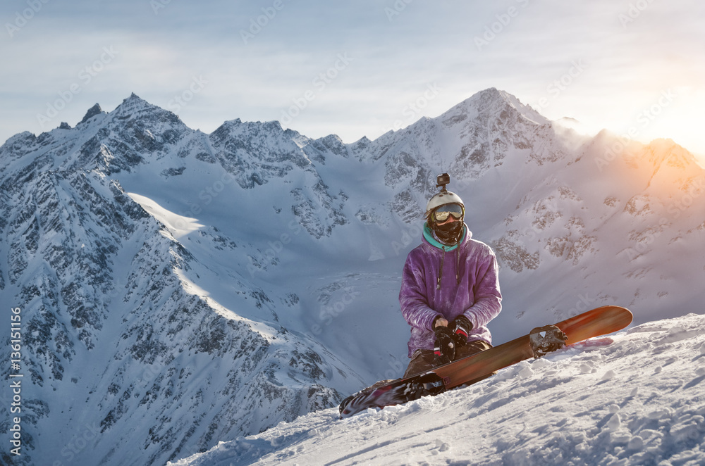 Snowboarder is sitting on mountain slopes of an extinct volcano Elbrus