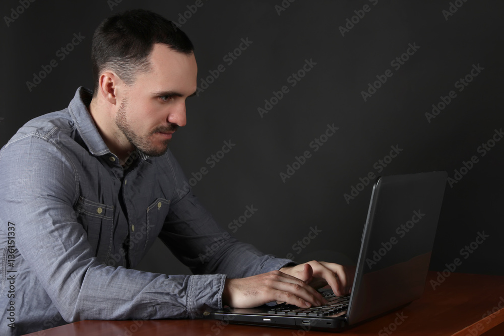A programmer working on a laptop. A programmer working on a laptop.