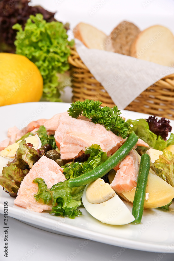 Salmon salad with asparagus on a white plate with fresh herbs Salmon salad with asparagus on a white plate with fresh herbs
