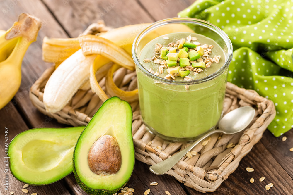 Avocado and banana smoothie with oats with ingredients in glass jar on wooden background, healthy eating - obrazy, fototapety, plakaty 