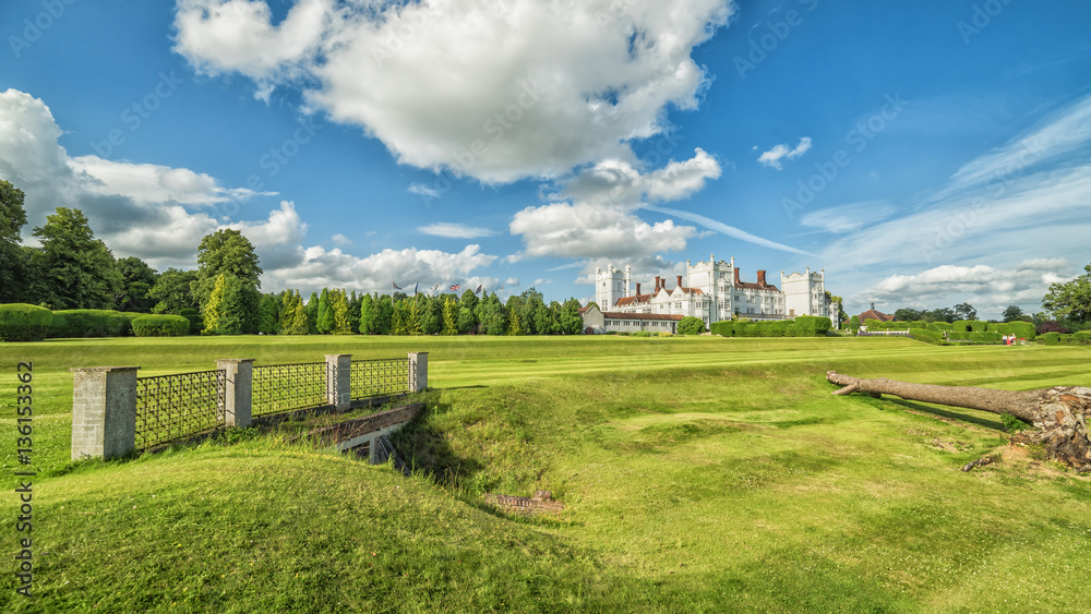 English summer panoramic landscape with small castle in background