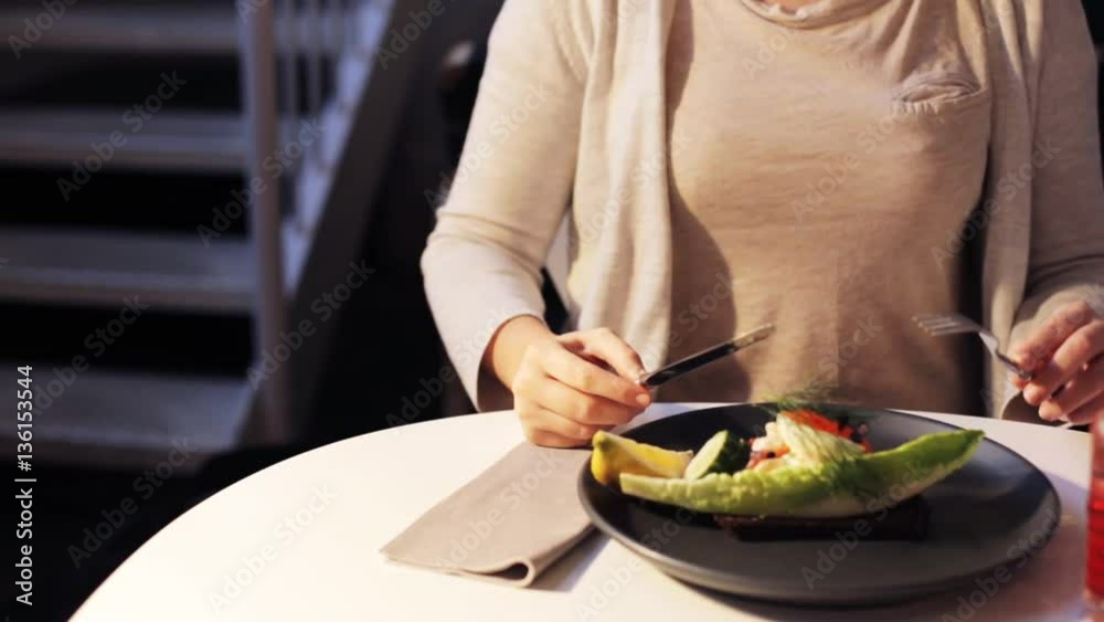 woman eating caviar toast skagen at restaurant woman eating caviar toast skagen at restaurant