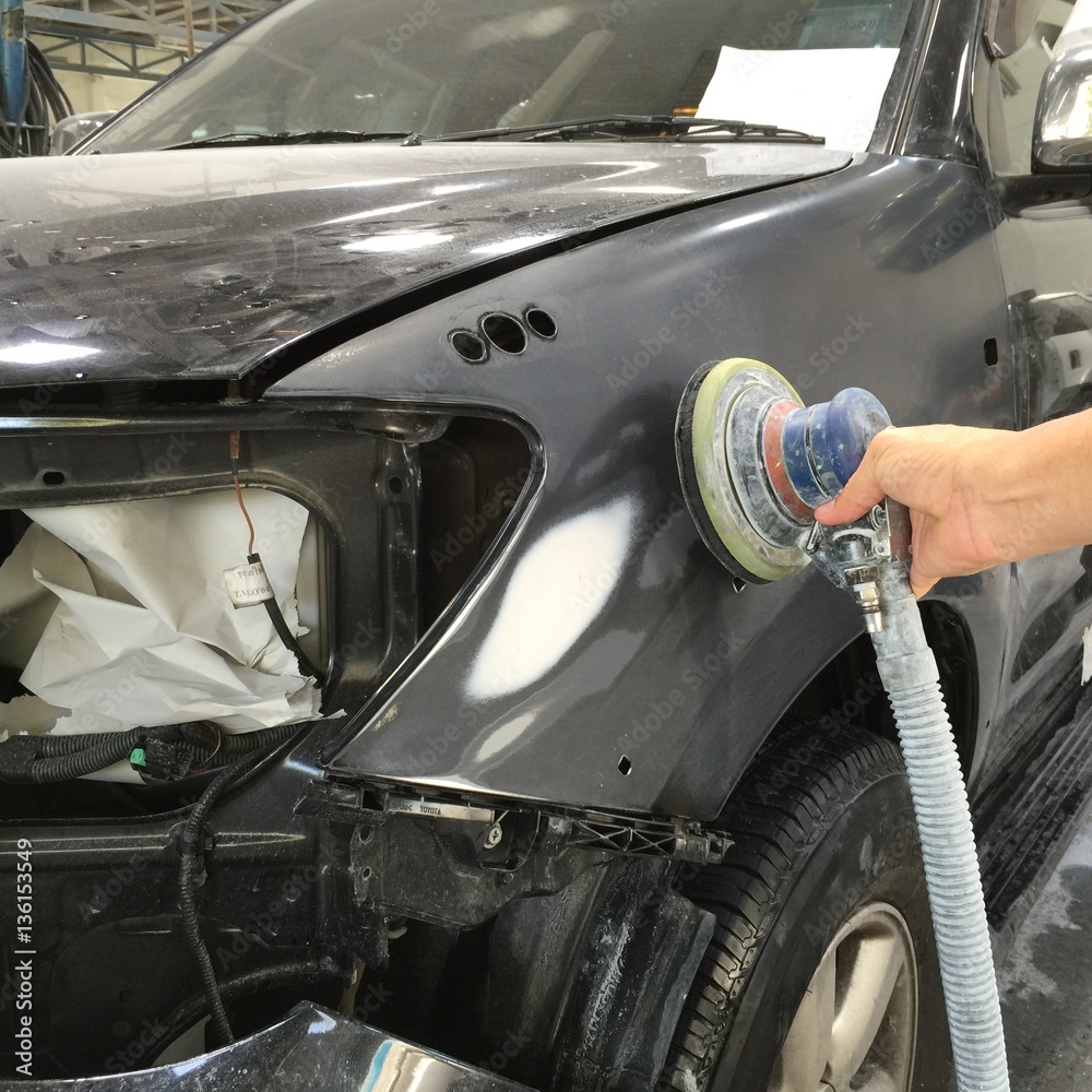 Garage Car body work auto repair car paint after car accident during the spraying