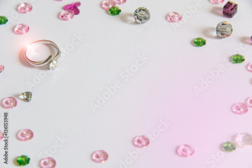 Diamond ring with colorful crystal decoration, light purple background