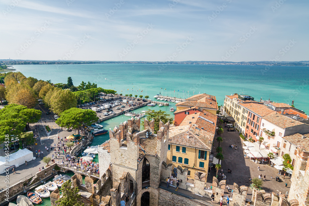 Sunny view of town from viewpoint of Rocca di Sirmione at Garda lake, Lombardia region, Italy.