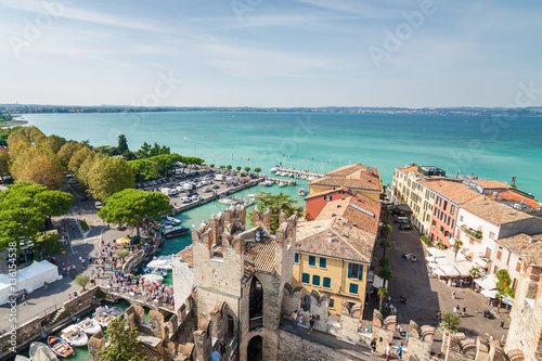 Sunny view of town from viewpoint of Rocca di Sirmione at Garda lake, Lombardia region, Italy.