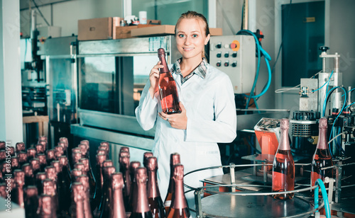 Woman working on wine production on manufactory