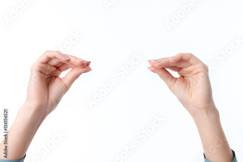 two female hands one opposite the other showing the gesture with his fingers clasped isolated on white background