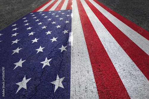 United states of america flag painted on straight aphalt road floor. photo