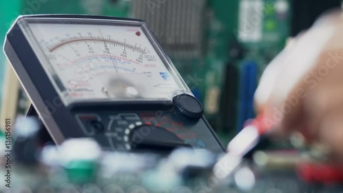 Closeup shot of a laboratory technician working with Multimeter
 photo