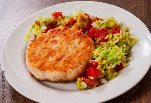 chicken burger with vegetables salad on plate