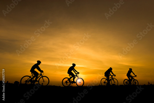 Silhouette of cycling on sunset background photo