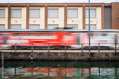 Smearing photo of a red streetcar in Milan