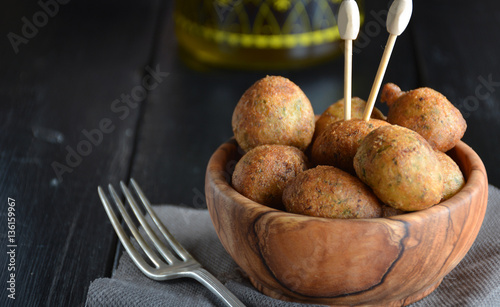  Fritters of cod home in a bowl of wood photo