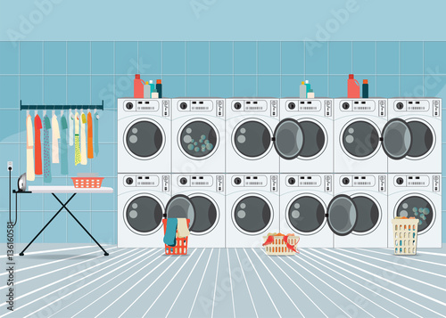 A row of industrial washing machines in laundry shop.
