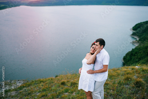 Loved couple in love at amazing landscape against cliff rocks.