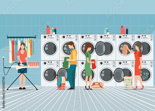 People in laundry room with row of industrial washing machines a