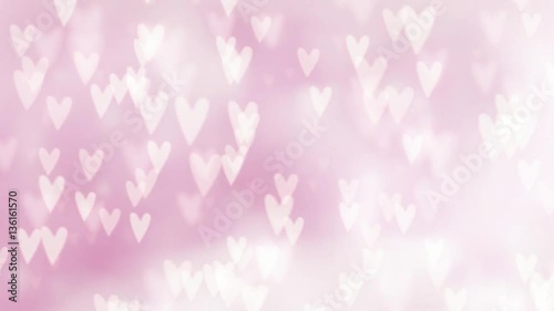 Valentines day or wedding abstract blurred background with falling hearts. Glittering bokeh lights. Love concept. Festive graphic HD animation.