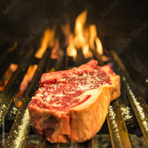 Cooking t-bone grilled steak in the barbecue