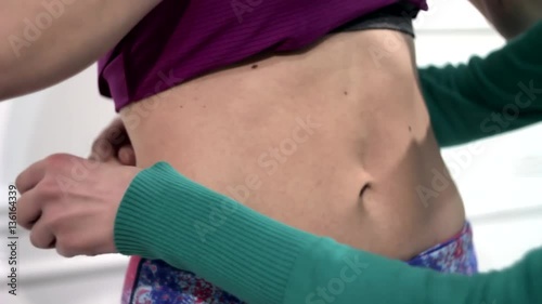 The girl measures the waist