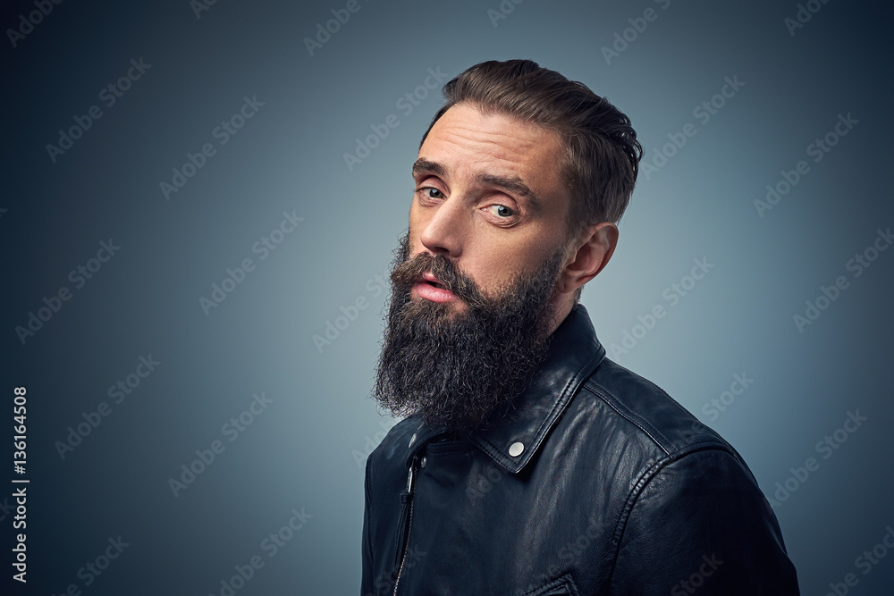 Bearded male dressed in black leather jacket. Bearded male dressed in black leather jacket.