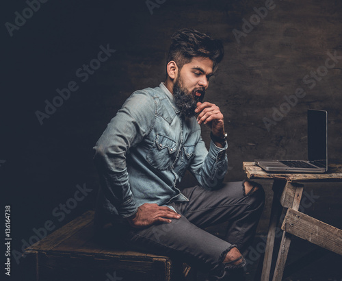 Stylish Indian male working with laptop.