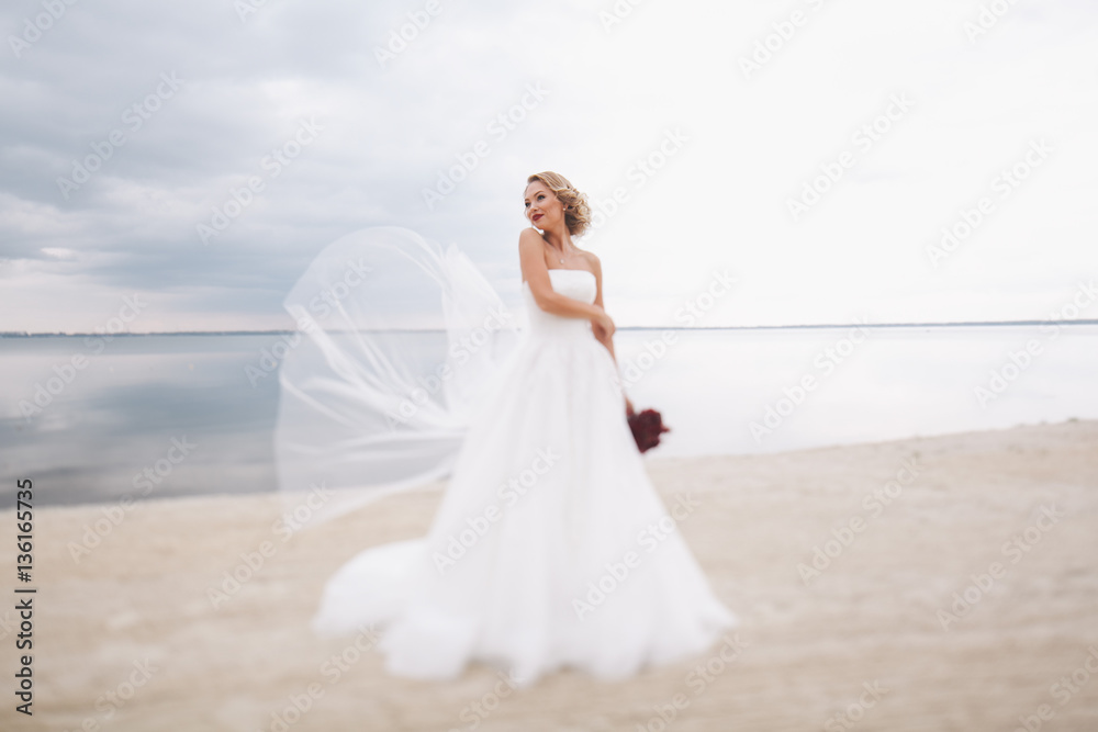 Portrait of beautiful bride in wedding day on the shore of the sea. Portrait of beautiful bride in wedding day on the shore of the sea.