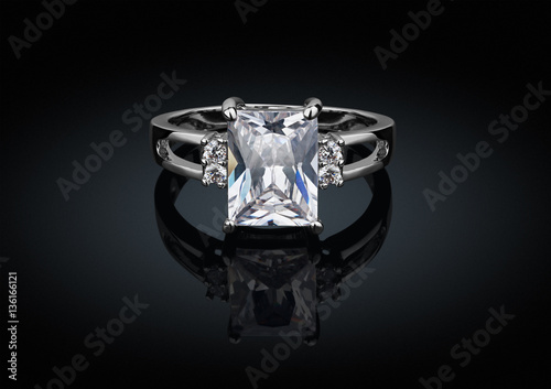 jewelry ring with big square clean diamond on black background w