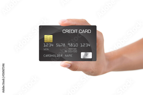 Female hand holding a bank card isolated on white background