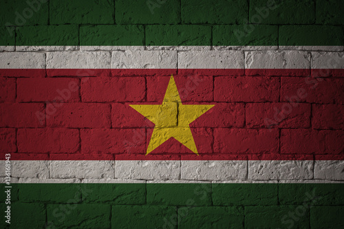 Flag with original proportions. Closeup of grunge flag of Suriname