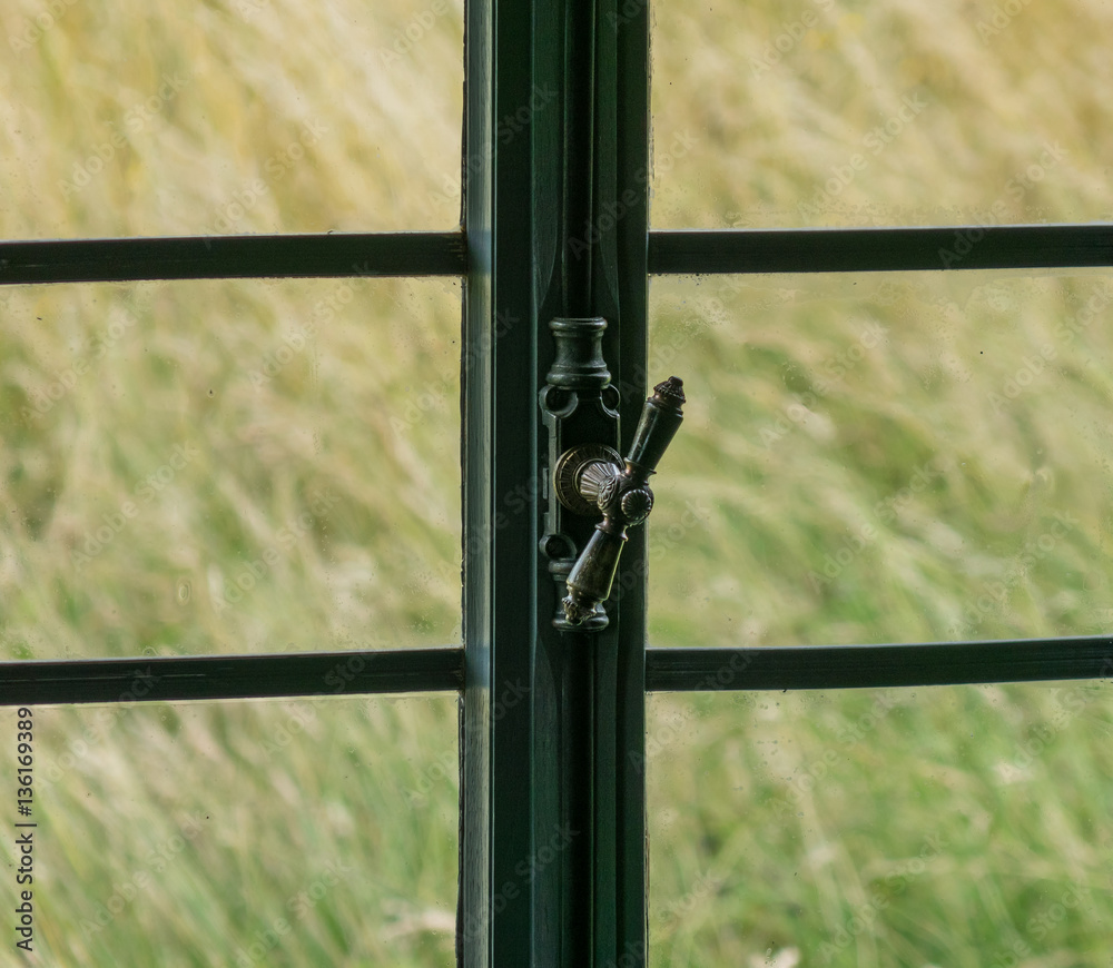 The window with latch of an old farmhouse inside The window with latch of an old farmhouse inside