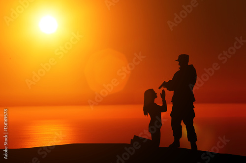 silhouette of a soldier put a gun to the head of the girl on a sunset background