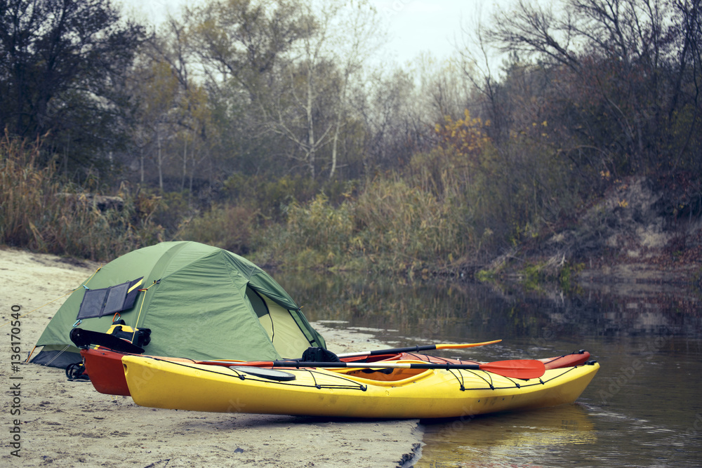Fototapeta premium Camping with kayaks on the river bank.