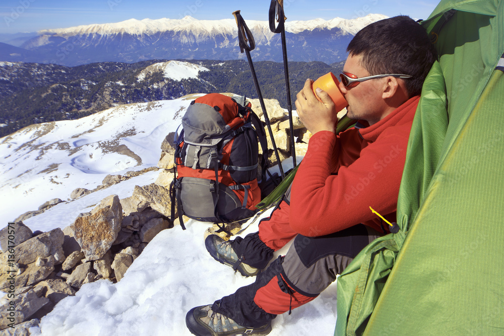 Winter hiking in the mountains with a backpack. Winter hiking in the mountains with a backpack.